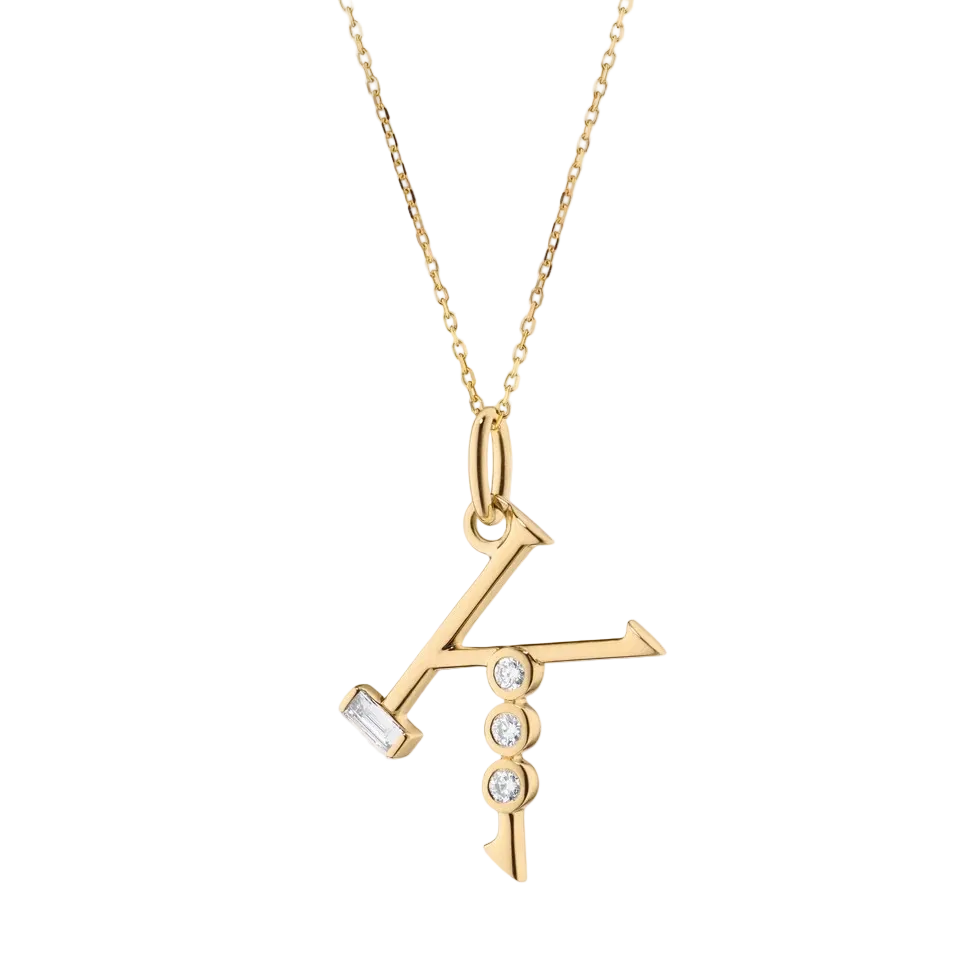 Initial K gold necklace with diamonds on a white background