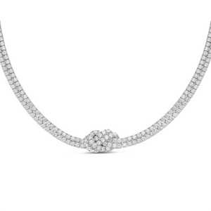 A silver-toned diamond necklace featuring a central knot design with a pavé setting of small round diamonds, shown against a plain white background.