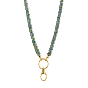 Green sapphire necklace with gold extender on a white background