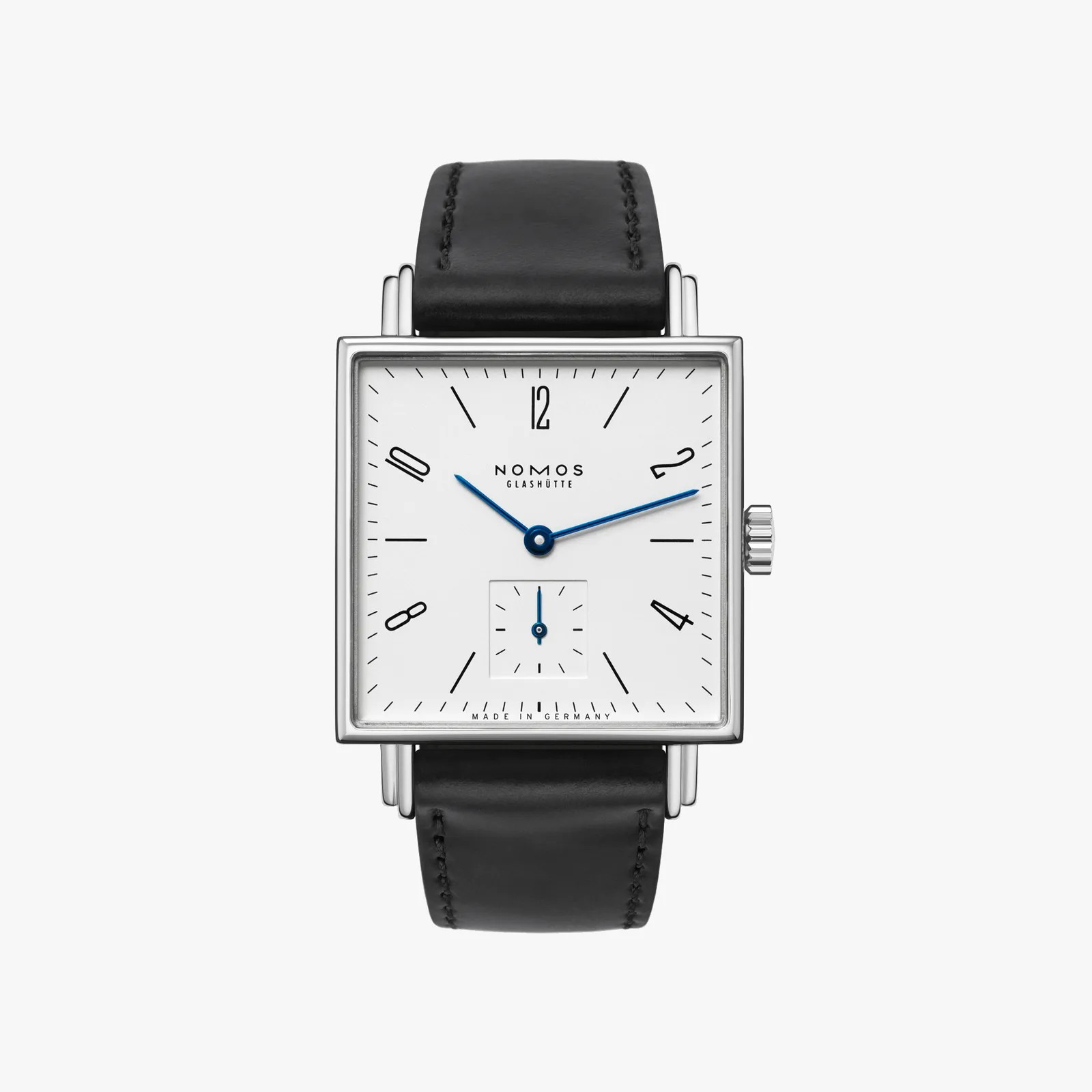 Nomos watch with black leather strap and white face on a light gray background