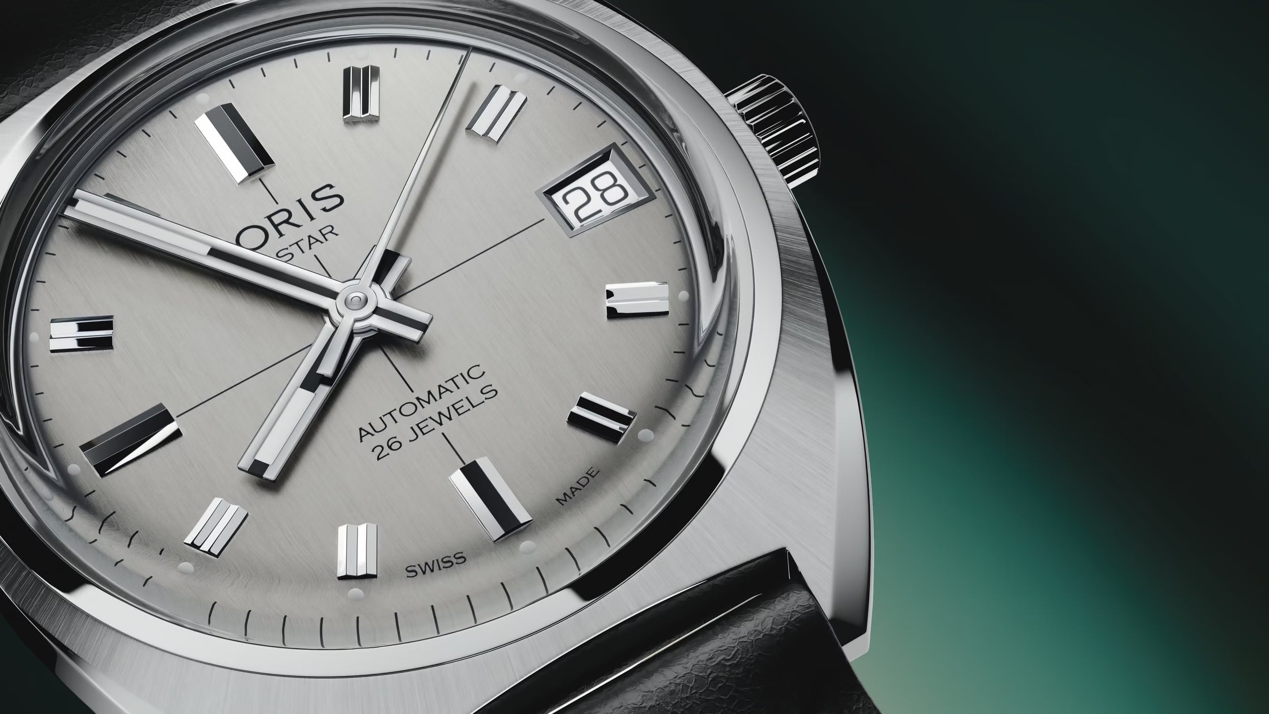 Oris watch with silver dial and black leather strap on a dark background