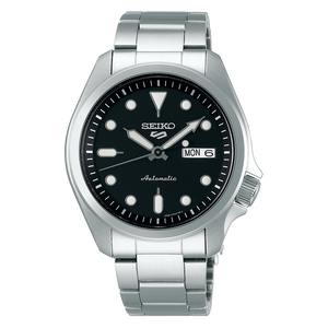 Seiko watch with black dial and silver metal strap on a white background