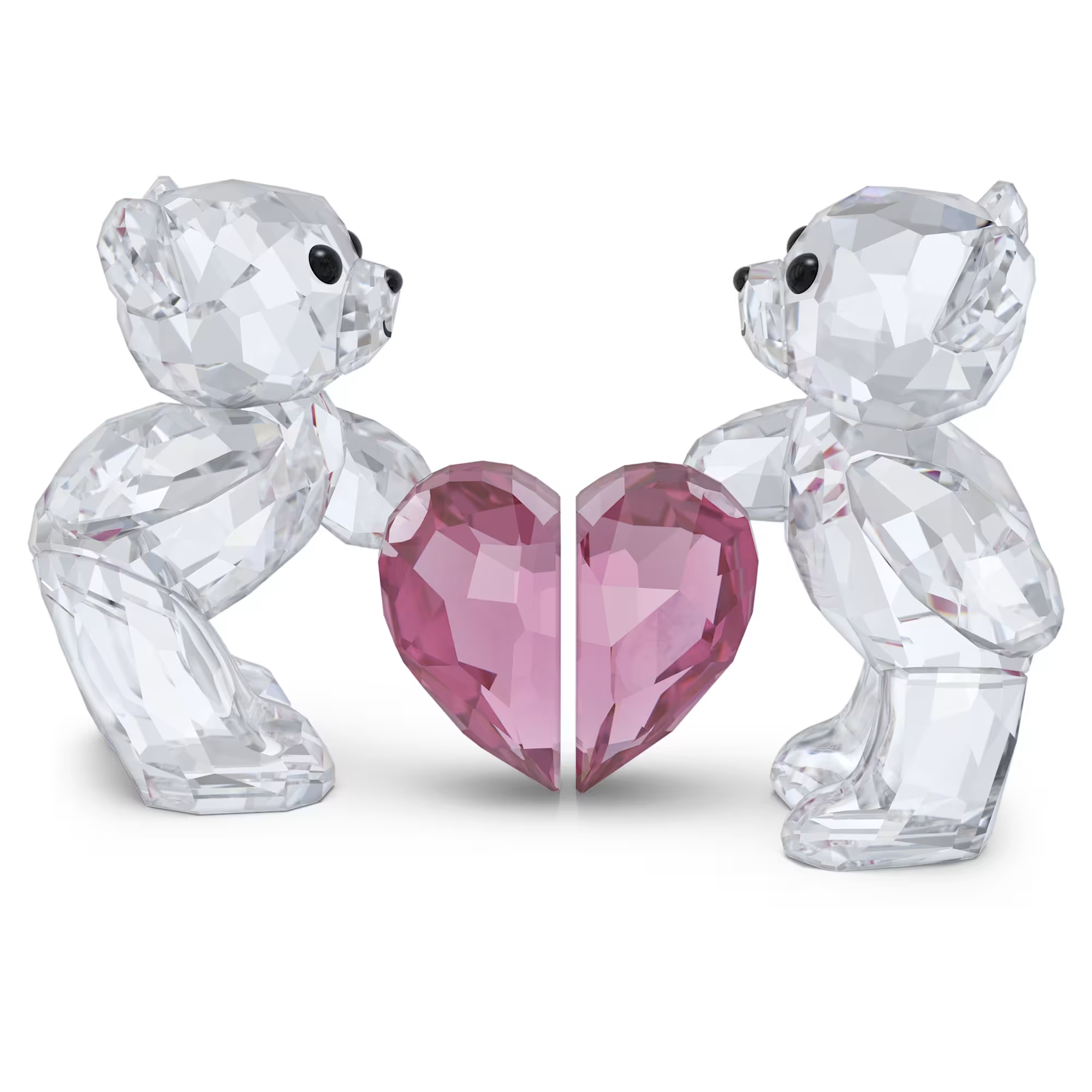 Two clear crystal teddy bears facing each other holding the two halves of a pink faceted heart.