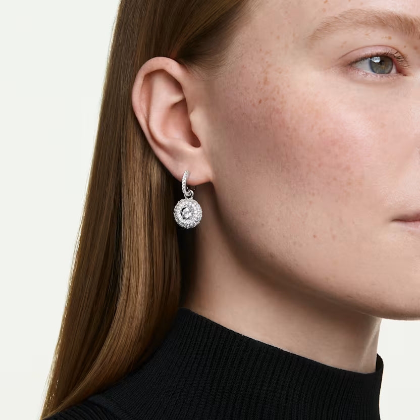a model wearing round cut drop earrings 