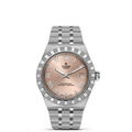 Front view of TUDOR Royal 36mm steel watch showing salmon dial, diamond bezel, and stainless steel bracelet on white