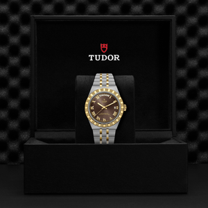 Tudor watch with gold and silver band in a black box with Tudor logo