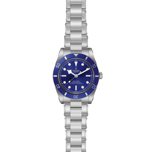 Front view of TUDOR Black Bay 54 stainless steel watch showcasing blue domed dial and 3-link bracelet on white background