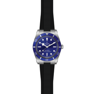 Front view of TUDOR Black Bay 54 watch showcasing blue domed dial and bezel, stainless steel case, and black rubber strap on white background