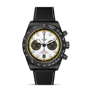 Black Tudor watch with a white face and yellow accents on a white background