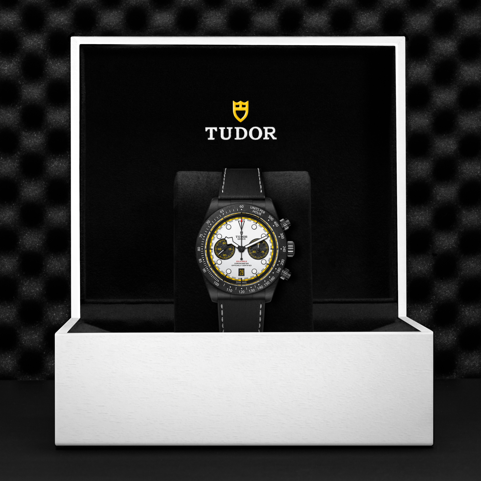 Tudor watch in a black box with a dark textured background