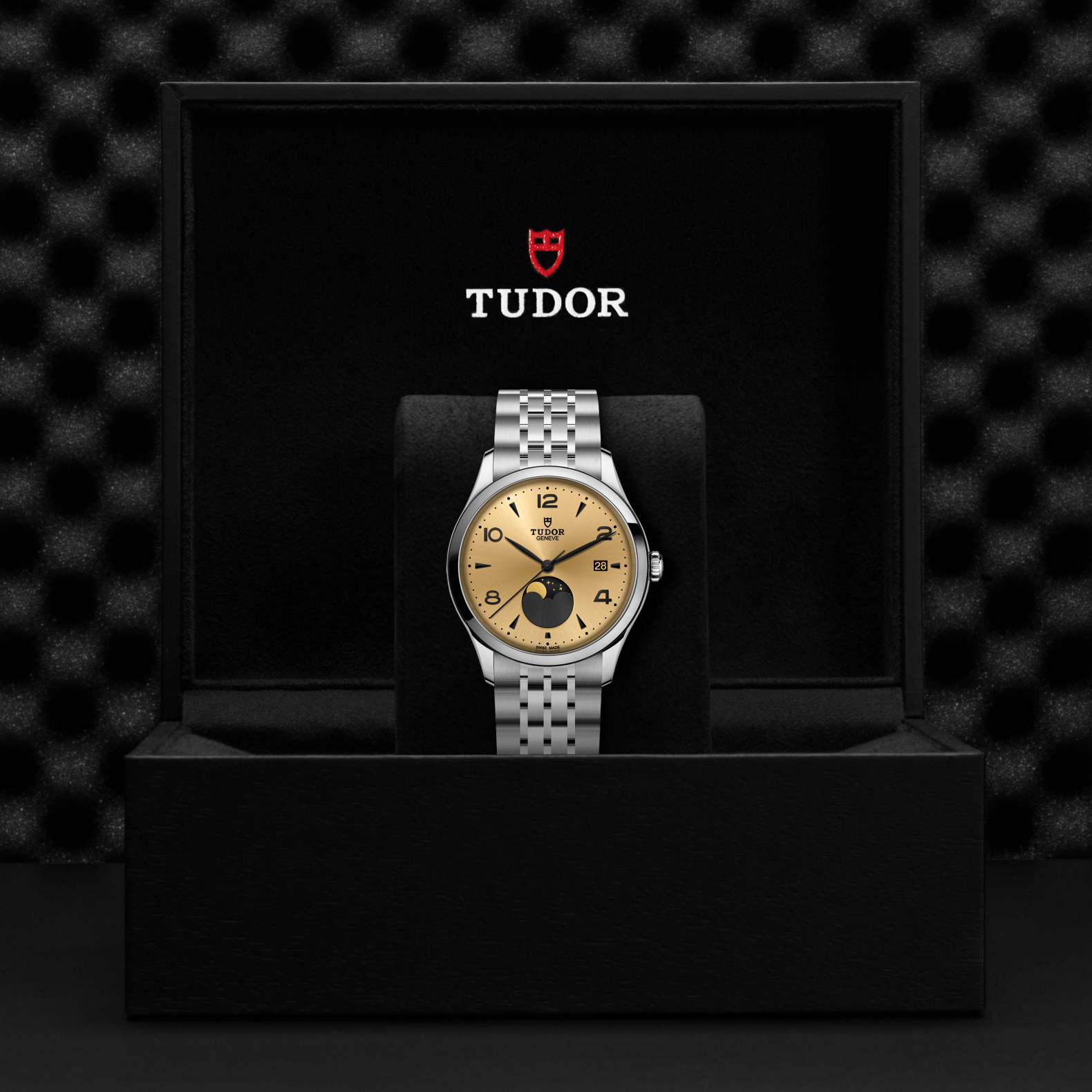 Front view of TUDOR 1926 Luna steel watch showing champagne dial with moon phase and steel bracelet in black Tudor box