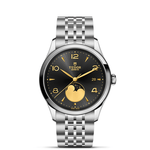 Front view of TUDOR 1926 Luna 39mm steel watch showcasing black sun-brushed dial with gold numerals, moonphase at 6, date at 3, and 7-row steel bracelet on white background