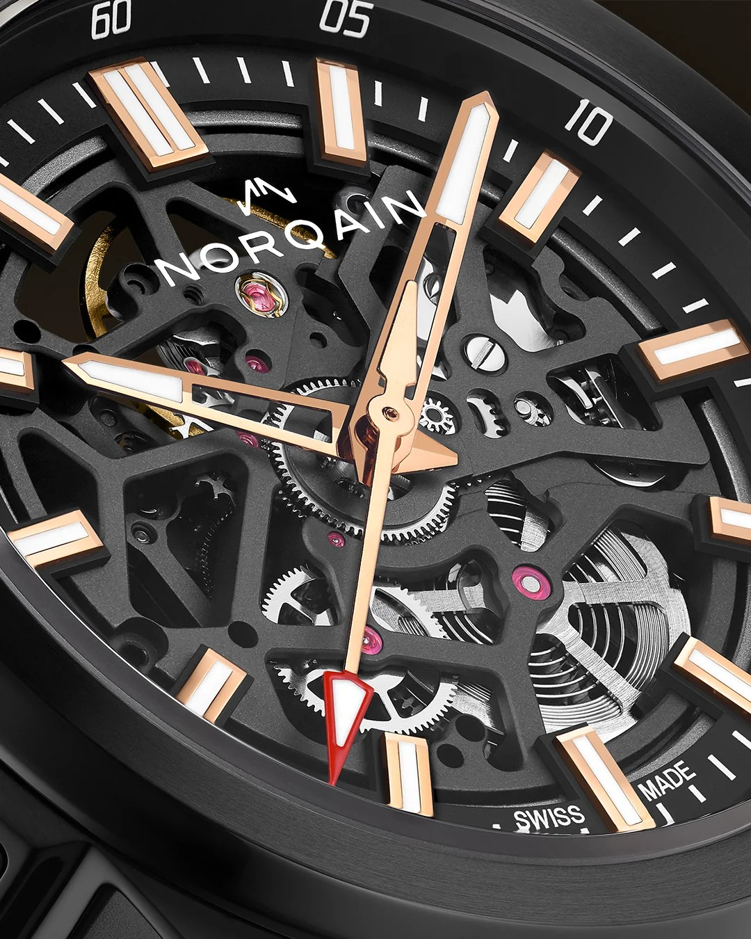 Close-up of a skeleton watch dial with black case and black open-worked face, rose-gold hour markers and hands, silver exposed gears, and a red seconds hand.