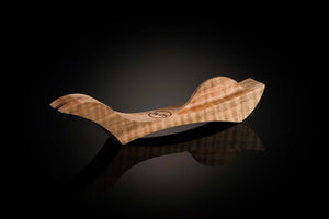 Wooden object with a reflective surface on a black background