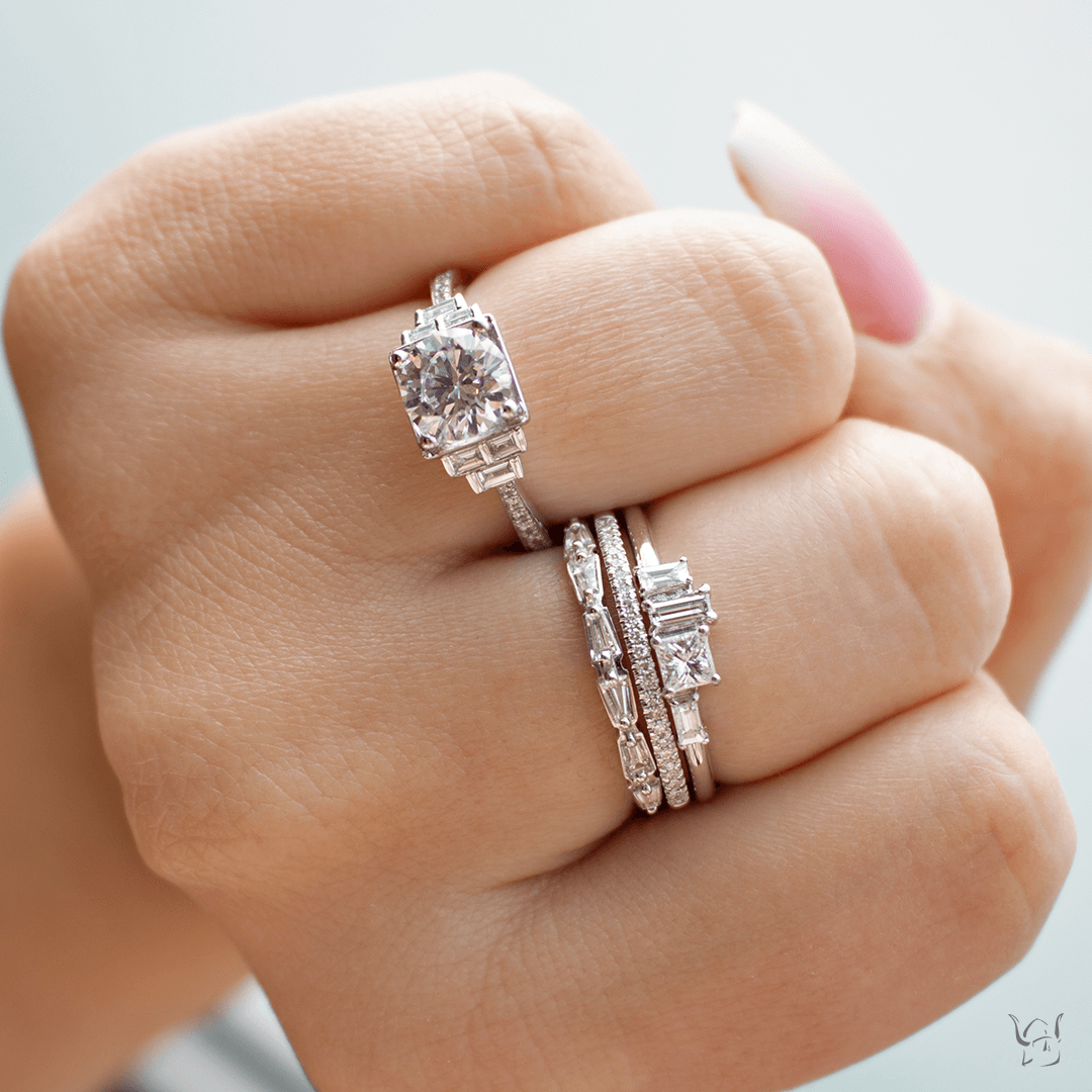 Three stacked diamond rings (14K white gold) on a finger, engagement ring with two diamond bands