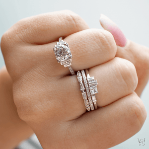 Three stacked diamond rings (14K white gold) on a finger, engagement ring with two diamond bands