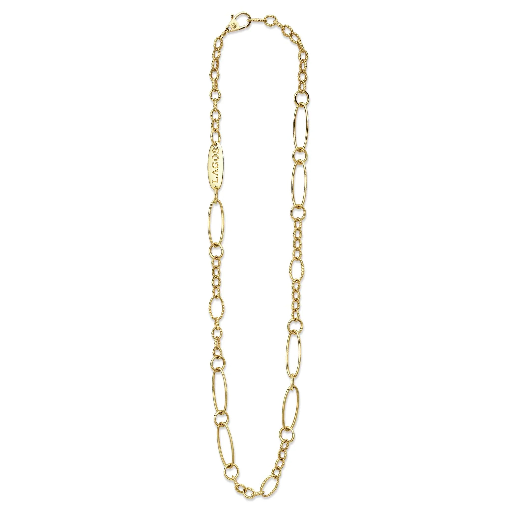 Flat lay of 18k gold link necklace showing alternating elongated oval links and textured caviar-beaded links on white background