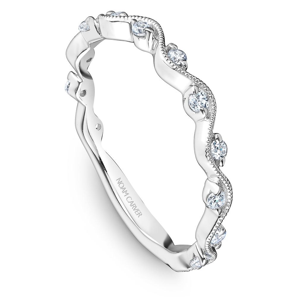 Angled view of 0.18ctw diamond wedding band showcasing scalloped milgrain design with round diamonds on white background