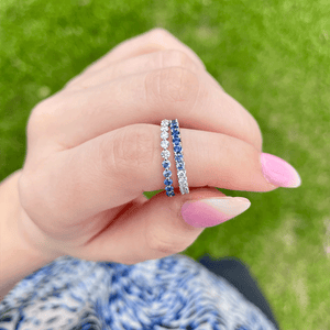 Close-up of Diamond & Blue Sapphire Ombre band showing pave diamonds transitioning to blue sapphires against blurred grass