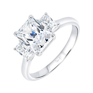 Emerald-cut center diamond flanked by two side diamonds in a polished platinum engagement ring, 0.60 ctw