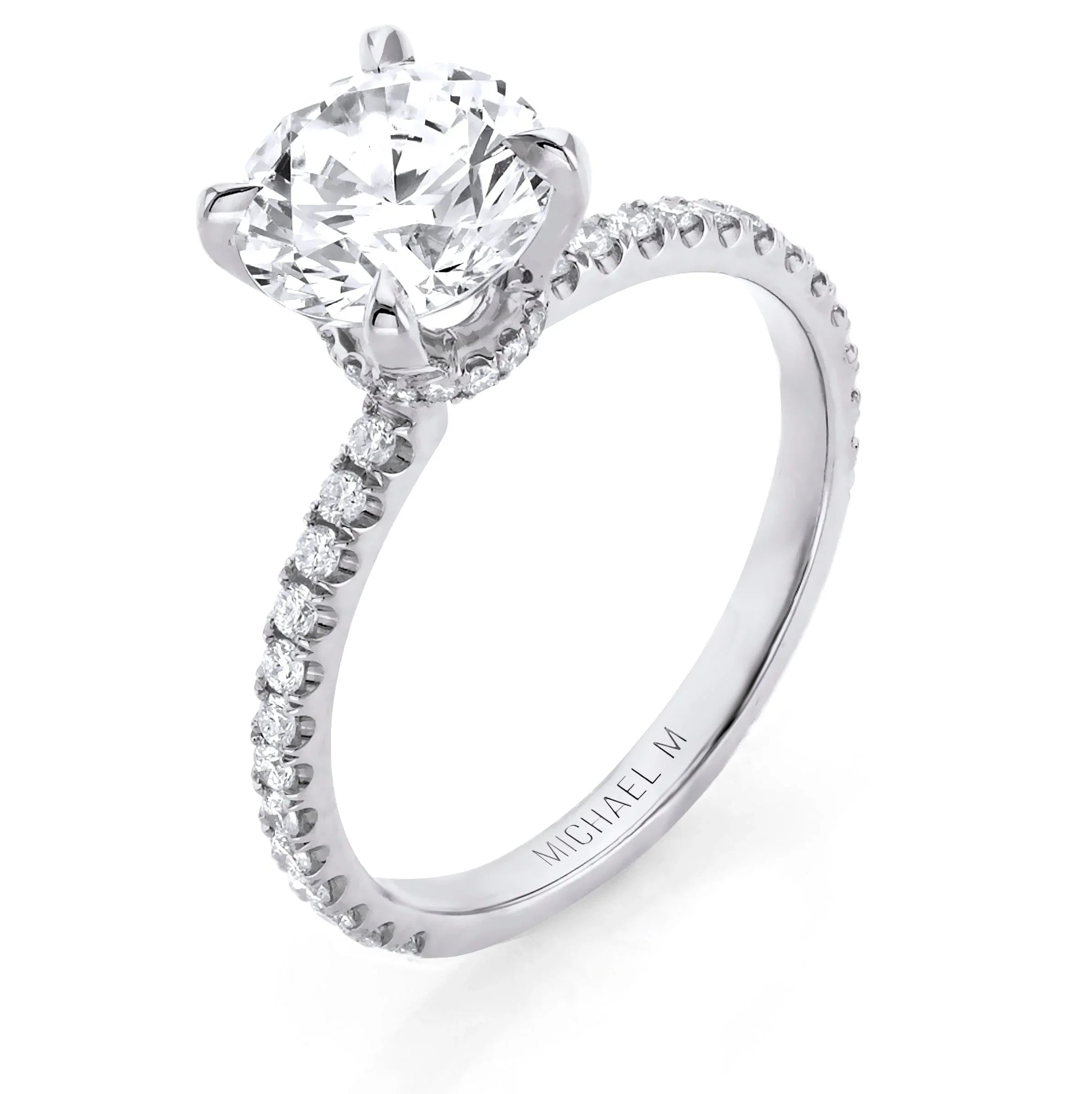 Solitaire engagement ring with pavé diamond band and round brilliant center stone, engraved MICHAEL M on inner shank.