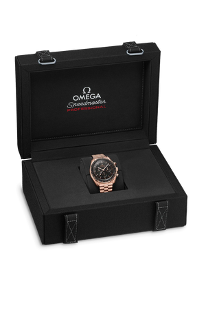 Three-quarter view of 42mm Omega Speedmaster Moonwatch in rose gold on bracelet in open black presentation box labeled 'OMEGA Speedmaster Professional'